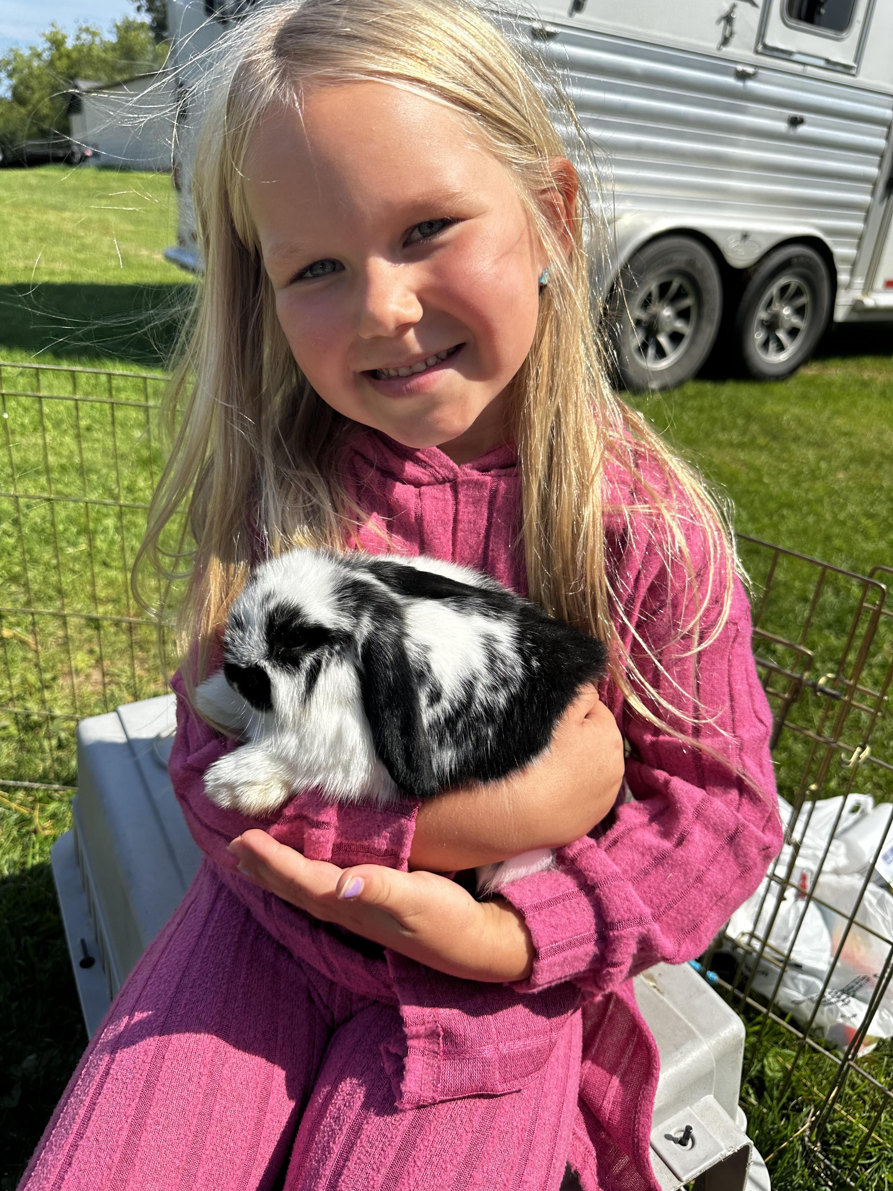 A girl holding a bunny from the Pony Parties Express petting zoo